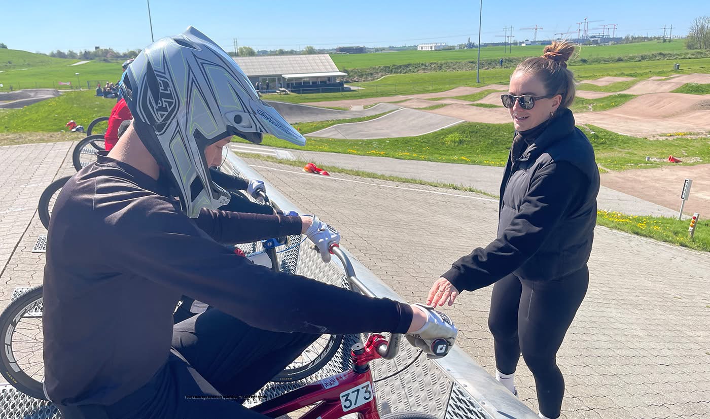 Dorte coaching a young BMX rider at the track